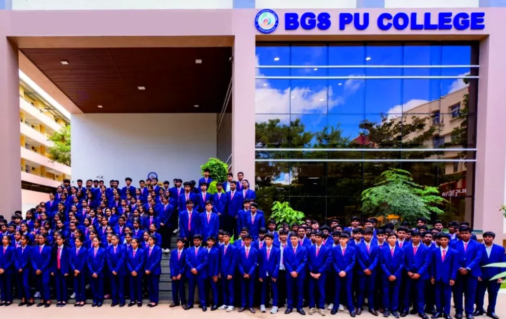 A large group of students in navy blazers in front of BGS PU College